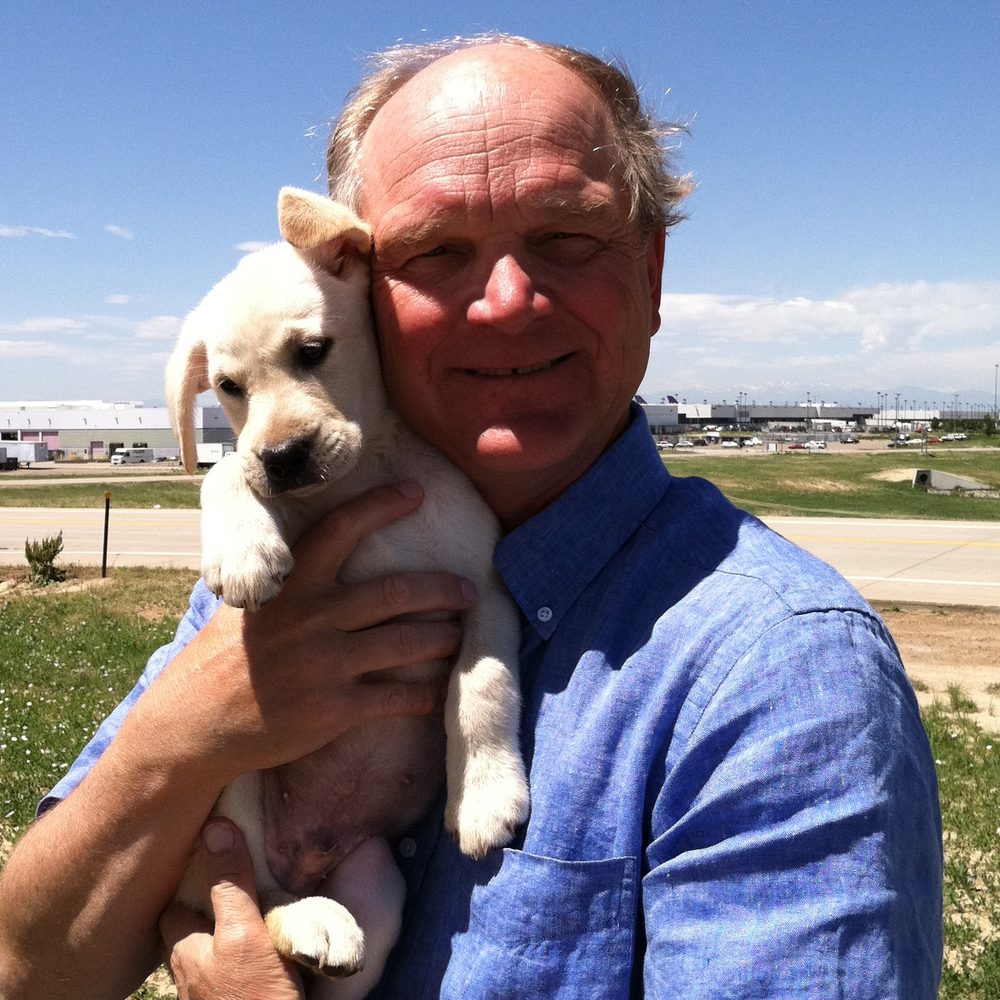 Barry Biegler holding his dog Zeus as a puppy